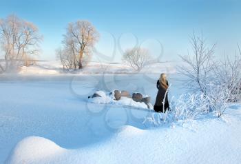 Royalty Free Photo of a Frosty Winter Scene With a Girl Standing in the Distance
