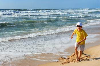 Royalty Free Photo of a Boy Playing in a Sand