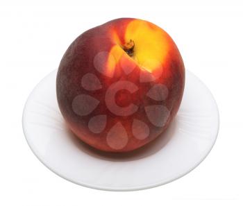 Ripe peach on a plate on a white background, isolated.