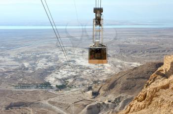 Cableway cabin descends from the fortress Masada.