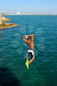 Teens, jumping into the sea from a height of city walls of Acre.