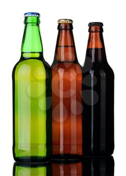 Bottles of lager and dark beer from brown and green glass, isolated on a white background.