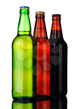 Bottles of lager and dark beer from brown and green glass, isolated on a white background.
