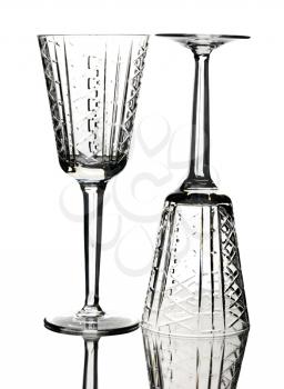 Two crystal wine glasses, isolated on a white background.