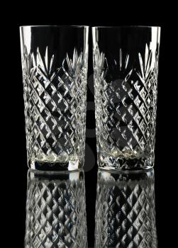 Two crystal glasses, isolated on a black background.