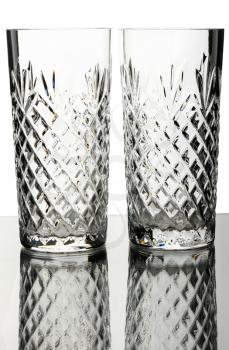 Two crystal glasses, isolated on a white background.