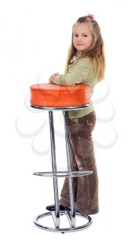 Girl with long blonde hair next to a high stool; isolated on a white background