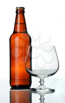 Bottle of beer and glass, isolated on a white background.