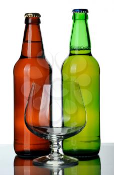 Two bottles of beer and glass, isolated on a white background.