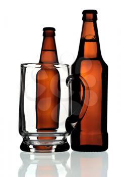 Glass mug and two bottles of beer on a white background, isolated