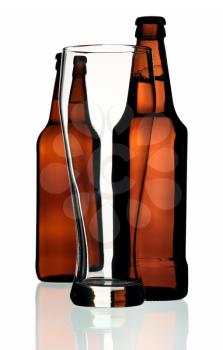 Glass and two bottles of beer on a white background, isolated