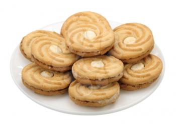 Pieces of brown sweet cookies on a white plate, isolated