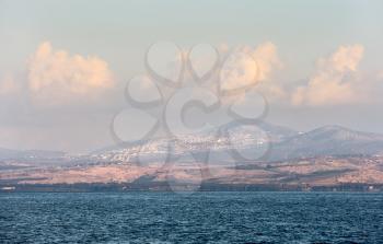 Sea of Galilee in the early morning, ripples on the water and clouds in the sky 