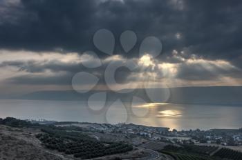 Lake Kinneret in the morning, sun rays are shining through the clouds 