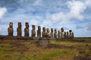Easter Island statues in line under the blue sky