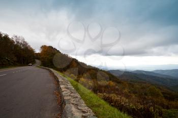 Royalty Free Photo of a Road and Autumn Colour on an Overcast Day