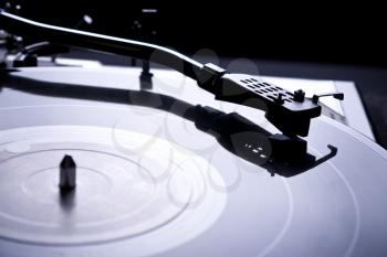 Royalty Free Photo of a Vinyl Record on a Turntable With Arm and Needle