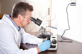 Royalty Free Photo of a Scientist Looking Into a Microscope