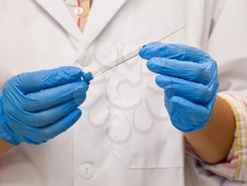 Scientist holds syringe for laboratory analysis