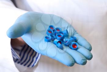 Scientists hand holds disposable caps for chromatography;