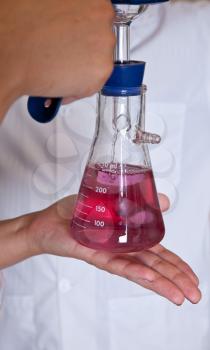 Filtrated clear permanganate solution in Buchner flask