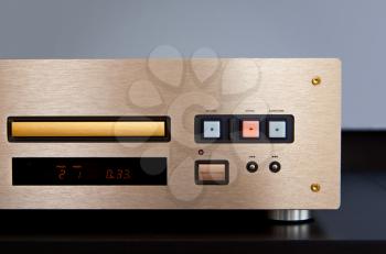 Expensive CD Player Playing Music with Golden Front Panel 