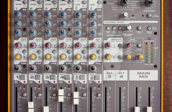 Audio studio sound mixer equalizer board controls faders sliders knobs, top view closeup
