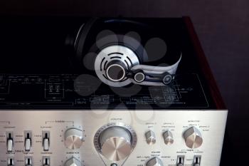 Audio Stereo Headphones on the top of Vintage AmplifierTop View