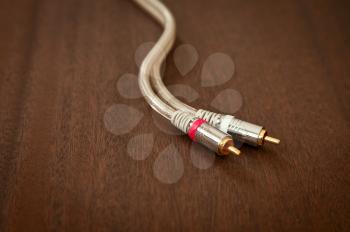 Component Inter Connect Audio Wire Cable with RCA Male Plug on Wooden Desk