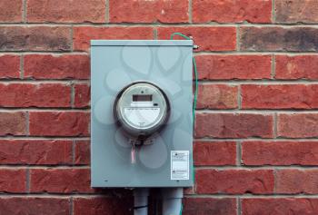 Electricity hydro power electric energy smart meter on the brick wall