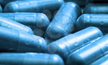 medicine - toned in blue background of film of pills