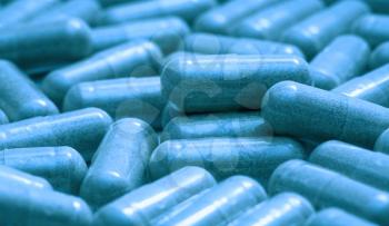 medicine - toned in blue background of film of pills