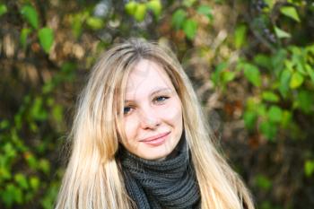 Young cute girl with long dark hairs with smile. Fall. Autumn. Outdoor session.