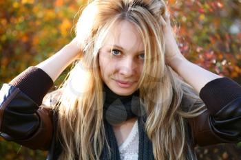 Young cute girl with long blond hairs. Fall. Autumn. Outdoor session.