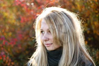Young cute girl with long blond hairs. Fall. Autumn. Outdoor session.