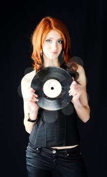 cute young pretty girl in stylish black wear with gramophone record