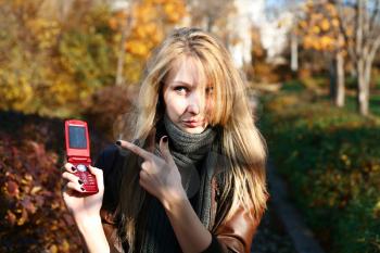 blond woman making a phone call outdoors (nature)