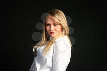 teenage blond girl portrait, studio shot on dark