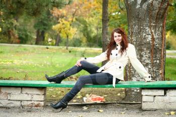 Portrait of a redheaded girl near a tree (autumn colors).