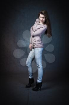 Beautiful Woman Portrait. Sexy Girl in jeans studio shot