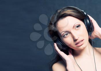 Sexy woman with headphones listening to music