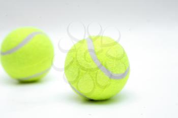 Closeup of two tennis balls isolated on white background.