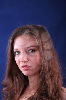 face of young beautiful woman on blue background