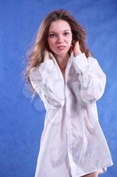 Portrait of a charming young lady on blue background