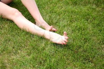 Womans bare feet on the fresh green grass