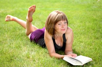 Portrait of beautiful relaxed young female student with a book