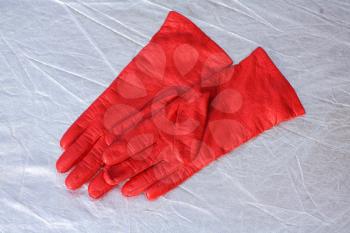 Red gloves isolated on silverbackground
