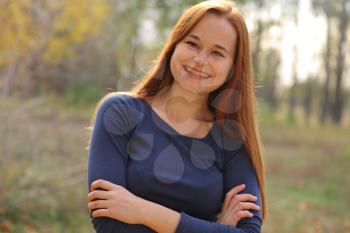 portrait of cute red haired young woman, outdoor