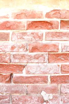 Old dilapidated brick wall of red brick
