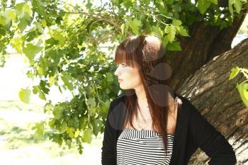 Beautiful brunette girl outdoors in summer